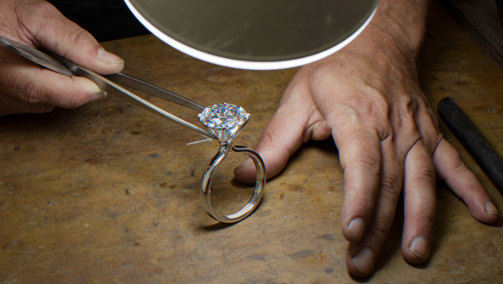 Seven carat diamond being set in a secure platinum mounting